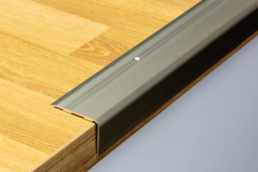 Aluminium stair trim close-up of drilled holes