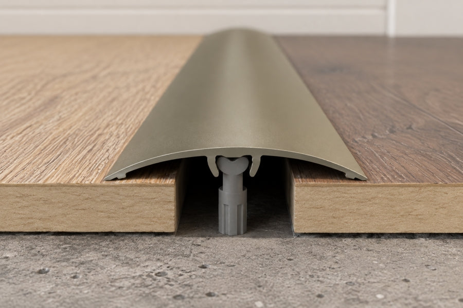 Underside of push-in aluminium door threshold strip showing the concealed fixing channel