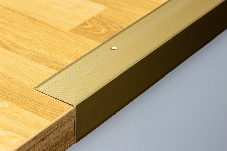Gold anodised stair nosing with screw holes