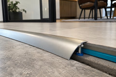 Aluminium door threshold strip in silver, gold and champagne finishes side by side